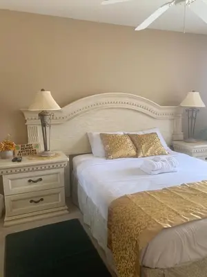 a bedroom with a bed and a nightstand with two lamps at Spacious Condo Close to Disney Attractions in Kissimmee