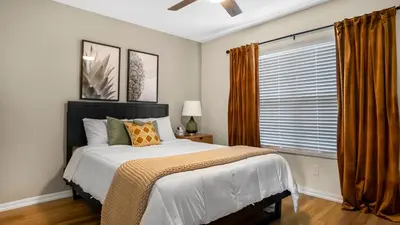 a bedroom with a large bed and a window at Beautiful 7 Bed Family Pool Home with Game Room-8510PHD in Kissimmee