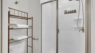 a bathroom with a shower and a toilet with towels at Canoe Landing in Orlando