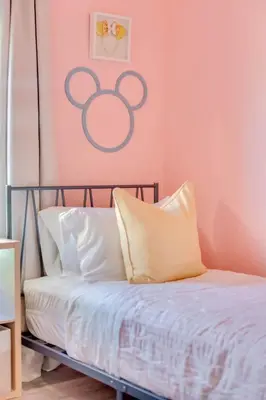 a bedroom with a bed with a pink wall at Lake view Pool home near Disney - 5BR 4BA in Kissimmee