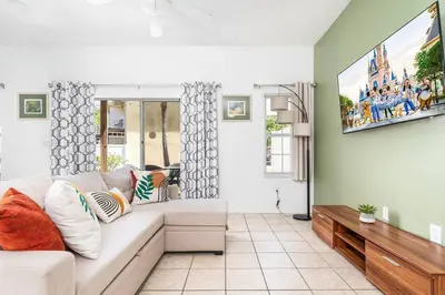 a living room with a couch and a tv at Your Home Away from Home! in Kissimmee