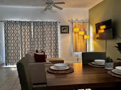 a living room with a table and a couch at Your Home Away from Home! in Kissimmee