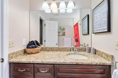 a bathroom with a sink and a large mirror at Dream Condo in Kissimmee