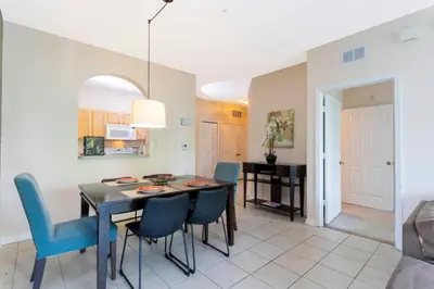 a dining room and living room with a table and chairs at Cozy Apartment 3BD2BA at Windsor Hills WH28131 in Orlando