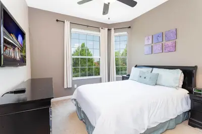 a bedroom with a large bed and a window at Cozy Apartment 3BD2BA at Windsor Hills WH28131 in Orlando