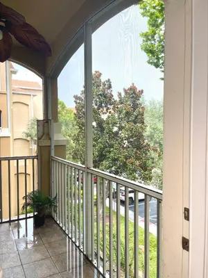 a balcony with a view of a tree at Cozy 3BR2BA Condo at Windsor Hills Resort WH76604 in Orlando