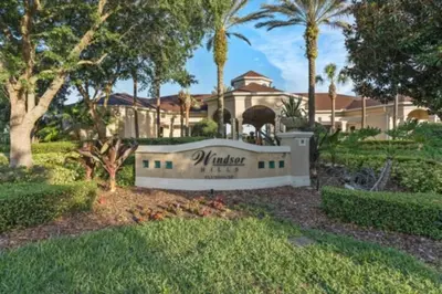a sign in front of a house with palm trees at Windsor Hills Magic,Resort Waterslides,Pool,Disney in Orlando