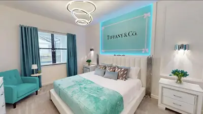 a bedroom with a large bed and a blue wall at Paradiso Grande 8BD Games Themed Rooms & Pool Spa in Orlando