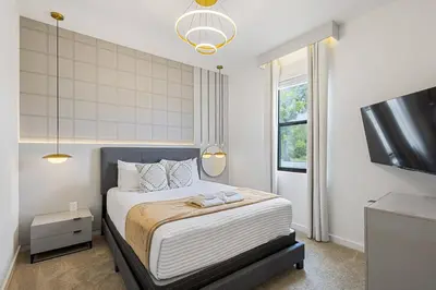 a bedroom with a bed and a flat screen tv at 3240 Townhouse Perfect for Disney Visits 3BD in Kissimmee
