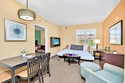 a living room with a couch and a table at Condo Near Universal Studio Apartment with Pool in Orlando