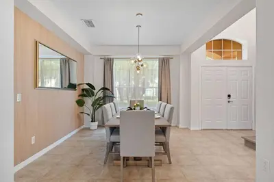 a dining room with a table and chairs at EPIC Theme 9D 360 Rotating Virtual Reality Machine 4 mi to Disney in Kissimmee