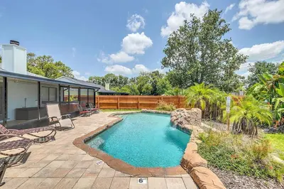 a swimming pool in the backyard of a house at Tranquil Oasis 4BR Pool Home in Orlando