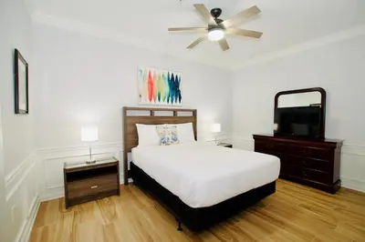 a bedroom with a bed and a flat screen tv at Vista Cay at Epic Universe - Luxury 4 bedroom Condo in Orlando