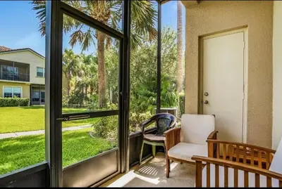 a porch with a chair and a sliding glass door at Disney Paradise-Family Friendly- Near to Disney in Orlando