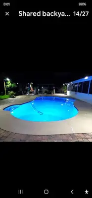 a large blue swimming pool at night at Pretige Studio in Orlando
