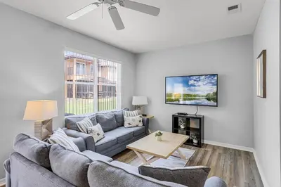 a living room with a couch and a table at Camaro in Orlando