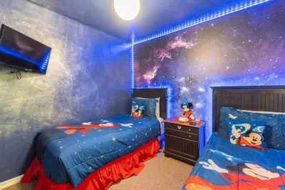 a bedroom with two beds and a space mural at Amazing Star Wars & Disney Vr Gaming House! in Kissimmee