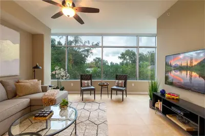 a living room with a couch and a flat screen tv at Stunning & Luxurious 2Bed 2Bath Open floor plan in Orlando