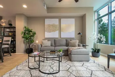 a living room with a couch and a glass table at Stunning & Luxurious 2Bed 2Bath Open floor plan in Orlando