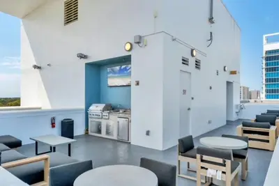 a room with tables and chairs in a building at Stunning & Luxurious 2Bed 2Bath Open floor plan in Orlando