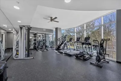 a gym with several treadmills and a large window at Stunning & Luxurious 2Bed 2Bath Open floor plan in Orlando