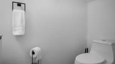 a bathroom with a toilet and a roll of toilet paper at Lovely 7 Bed Pool Home with Game Room-8510PHD home in Kissimmee