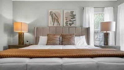 a bedroom with a large bed with two lamps at Lovely 7 Bed Pool Home with Game Room-8510PHD home in Kissimmee