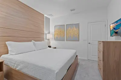 a white bedroom with a bed and a dresser at Brand NEW 12Bed12Bath At Paradiso Grande in Orlando