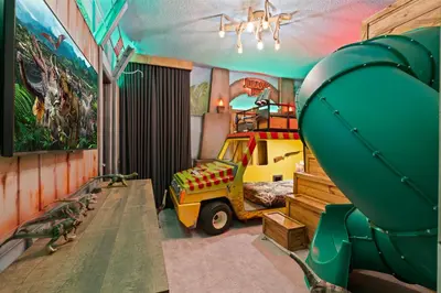 a childs room with a dinosaur bed and a slide at Brand NEW 12Bed12Bath At Paradiso Grande in Orlando