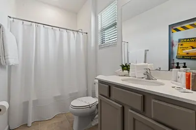 a white bathroom with a toilet and a sink at Brand NEW 12Bed12Bath At Paradiso Grande in Orlando