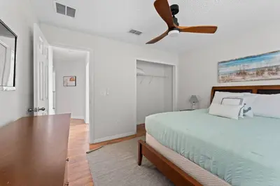 a bedroom with a bed with a ceiling fan at 7BR Family Friendly Resort Pool Home Near Disney World in Kissimmee