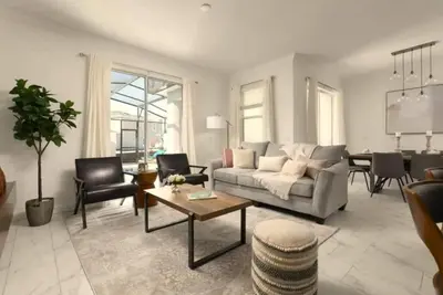 a living room with a couch and a table at Your 4-Bedroom Getaway, Only 9 Miles from Disney in Kissimmee