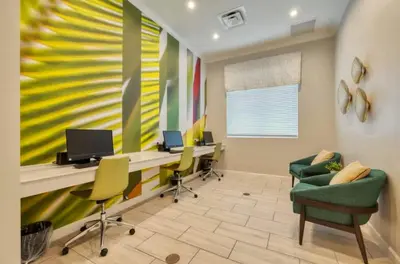 an office with chairs and a desk with a computer at Your 4-Bedroom Getaway, Only 9 Miles from Disney in Kissimmee