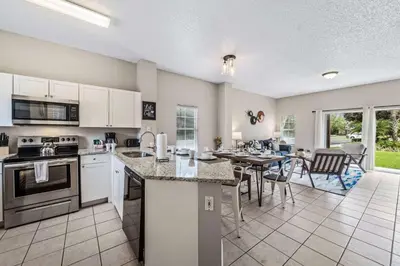 an open kitchen and dining room with a table at 8400 Blue Lagoon Drive in Kissimmee