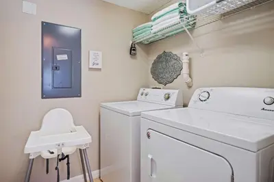 a laundry room with a washing machine and a sink at 8400 Blue Lagoon Drive in Kissimmee