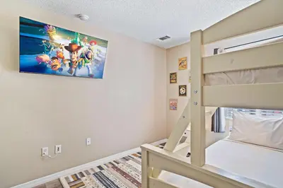 a childs bedroom with a bunk bed and a painting on the wall at 8400 Blue Lagoon Drive in Kissimmee