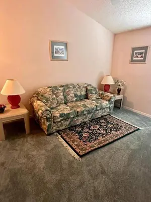 a living room with a couch and two lamps at Creekside Kissimmee in Kissimmee