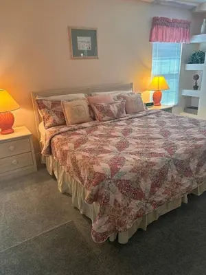 a bedroom with a bed and two lamps and a window at Creekside Kissimmee in Kissimmee