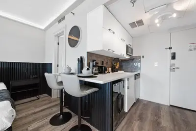a kitchen with a table and chairs in a room at Studio Close to Universal Intl Drive in Orlando