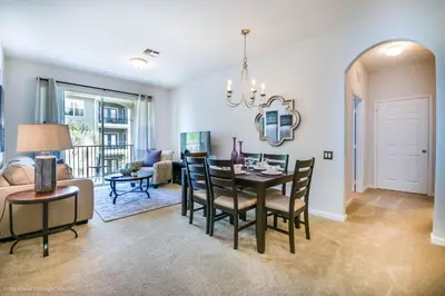 a dining room and living room with a table and chairs at Cozy Vista Cay Condo right next to Clubhouse in Orlando