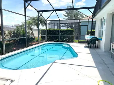 a swimming pool in the middle of a patio at Windsor Palm Resort 3 miles to Disney 4 Bedrooms in Kissimmee