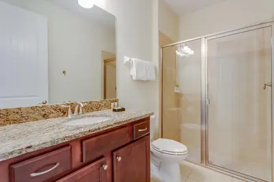 a bathroom with a shower and a toilet and a sink at Fairytale Retreat in Orlando