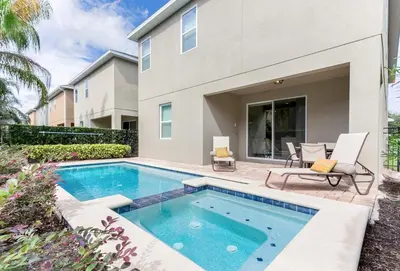 a swimming pool in front of a house at Fairytale Retreat in Orlando