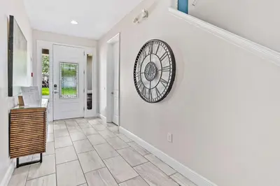 a hallway of a home with a clock on the wall at Magic Manor in Orlando