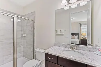a bathroom with a toilet and a sink and a shower at Magic Manor in Orlando
