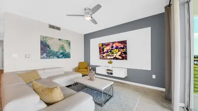 a living room with a couch and a table at WaterLily at Storey Lake in Orlando
