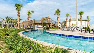a pool at a resort with palm trees at WaterLily at Storey Lake in Orlando