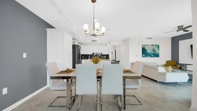 a dining room and living room with a table and chairs at WaterLily at Storey Lake in Orlando