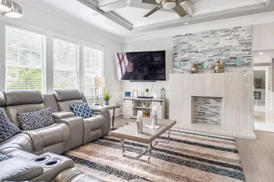 a living room with a couch and a fireplace at LUXURY 6000 sqft Mansion in Downtown Orlando Sleeps 12 in Orlando