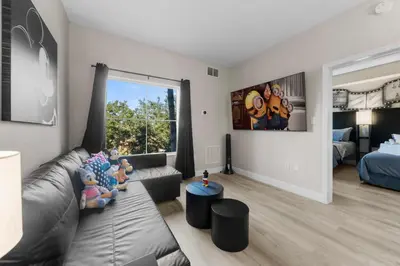 a living room with a couch and a large window at DisneyShuttleKing & Queen Be 5 minutes to Disney in Orlando